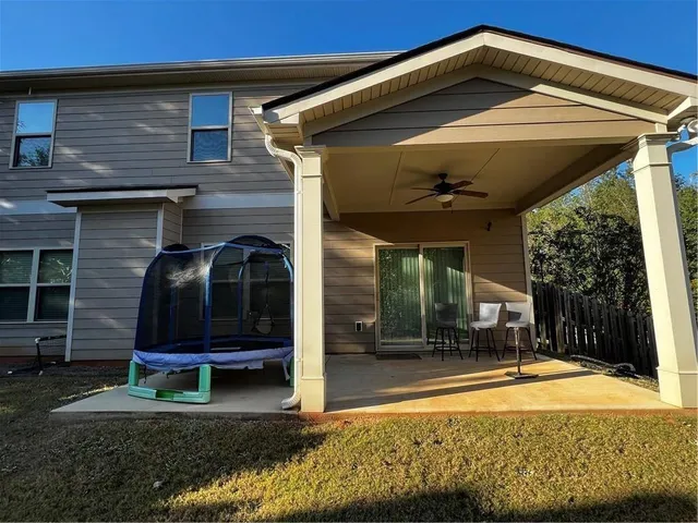 a view of a house with backyard porch and sitting area