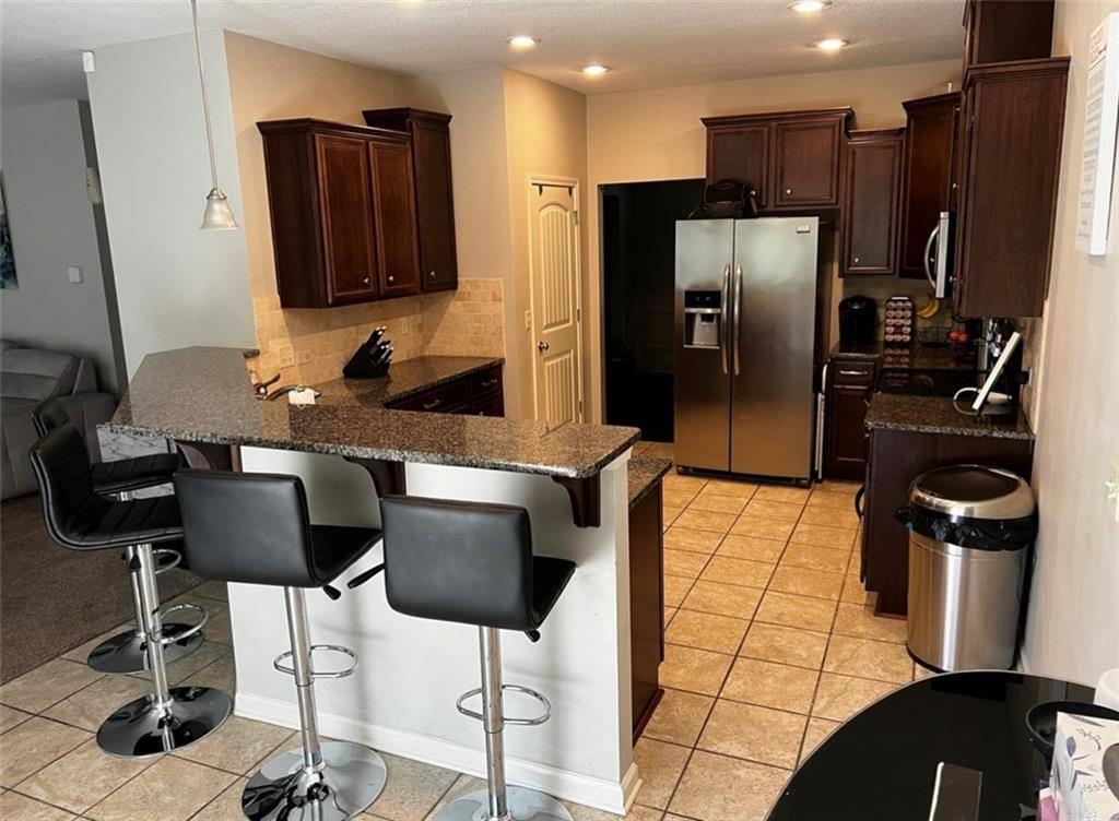 7426 Sorrel Court Columbus, GA 31909 - Photo 9 of 23 a kitchen with stainless steel appliances granite countertop a refrigerator and a stove top oven