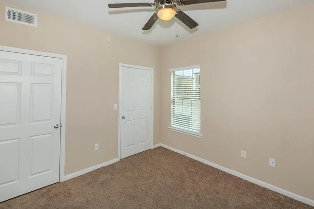 a white toilet sitting next to a bath tub
