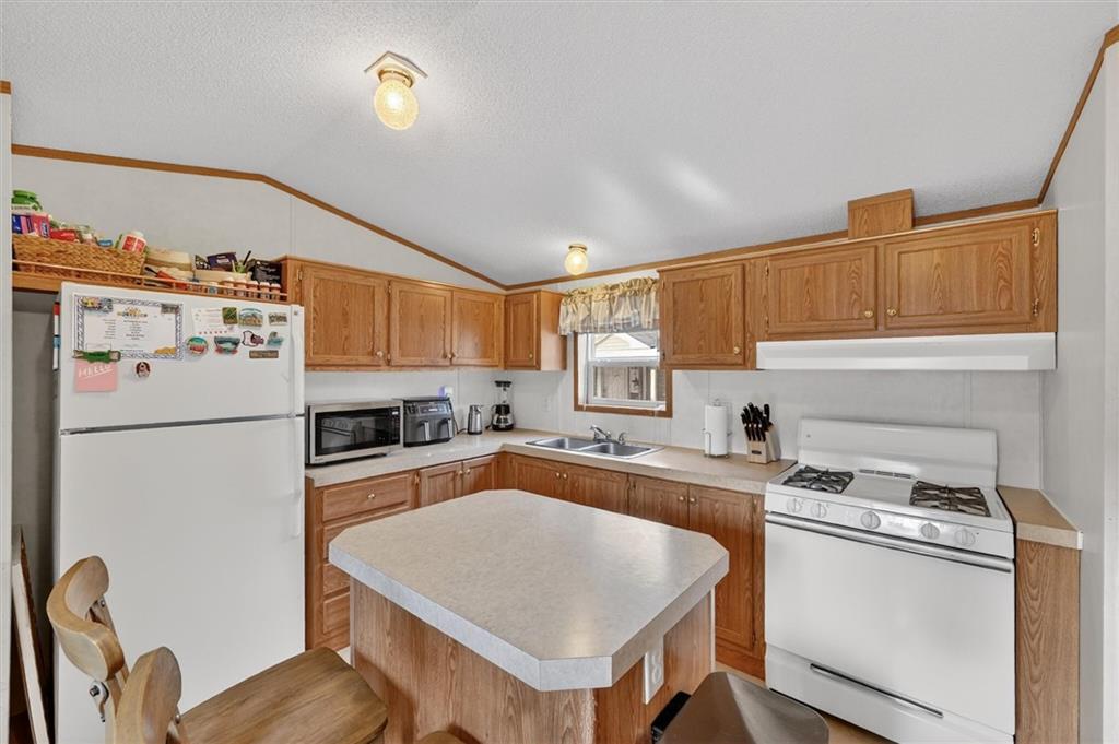 640 Deana Way Rochester, PA 15074 - Photo 7 of 20 a kitchen with a refrigerator a stove a sink dishwasher and cabinets with wooden floor