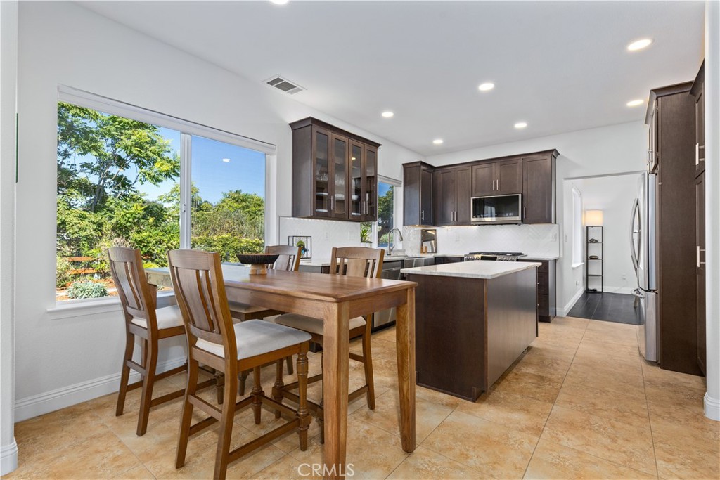 142 Via Camelia Paso Robles, CA 93446 - Photo 11 of 43 a kitchen with kitchen island a table and chairs in it
