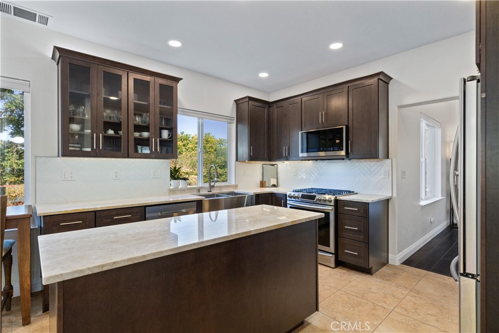 142 Via Camelia Paso Robles, CA 93446 - Photo 12 of 43 a kitchen with stainless steel appliances granite countertop a sink and a stove