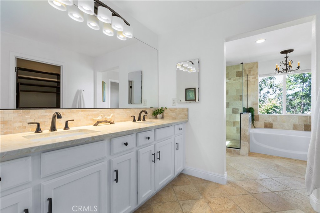 142 Via Camelia Paso Robles, CA 93446 - Photo 20 of 43 a spacious bathroom with a granite countertop sink a large mirror and a bathtub