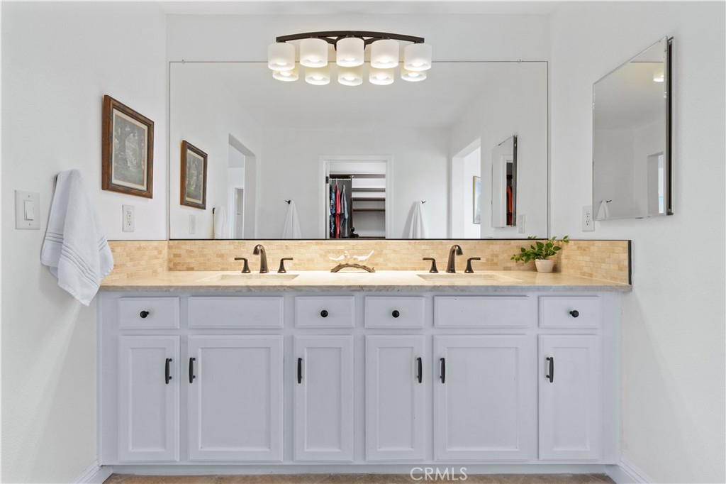 142 Via Camelia Paso Robles, CA 93446 - Photo 22 of 43 a bathroom with double vanity sink a mirror and bathtub