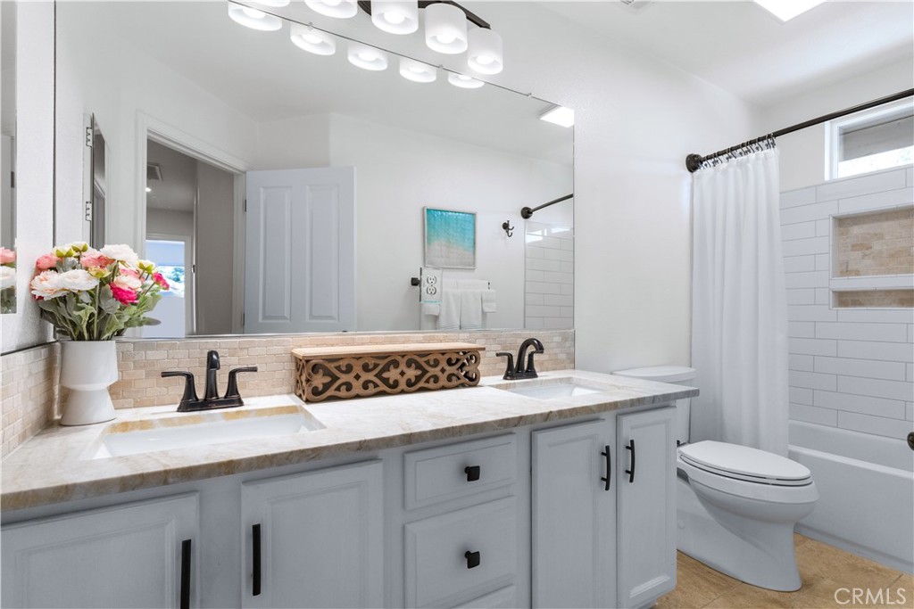 142 Via Camelia Paso Robles, CA 93446 - Photo 28 of 43 a bathroom with a sink a toilet and mirror