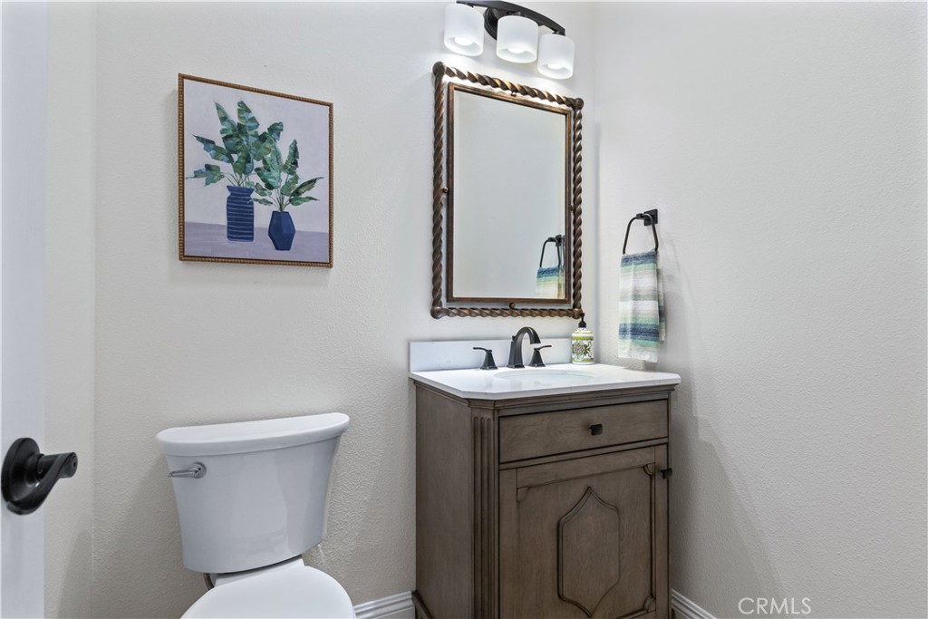 142 Via Camelia Paso Robles, CA 93446 - Photo 29 of 43 a bathroom with a toilet a sink and mirror