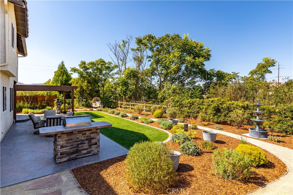 142 Via Camelia Paso Robles, CA 93446 - Photo 35 of 43 a backyard of a house with yard and outdoor seating