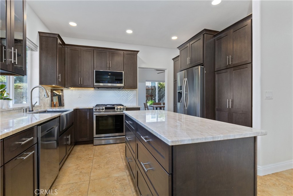 142 Via Camelia Paso Robles, CA 93446 - Photo 6 of 43 a kitchen with a sink stove and refrigerator