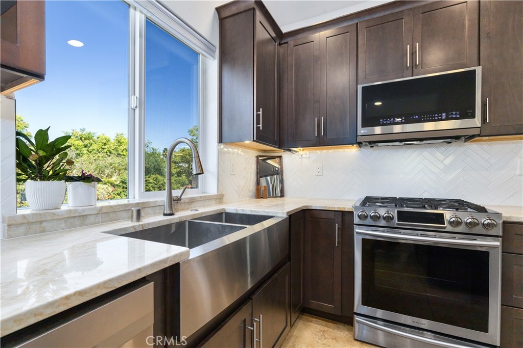 142 Via Camelia Paso Robles, CA 93446 - Photo 8 of 43 a kitchen with a sink and steel appliances