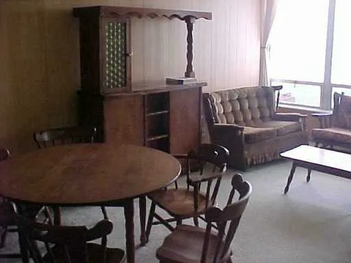 a view of a dining room with furniture and a window