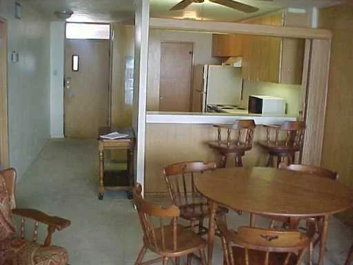 a dining room with furniture and a mirror