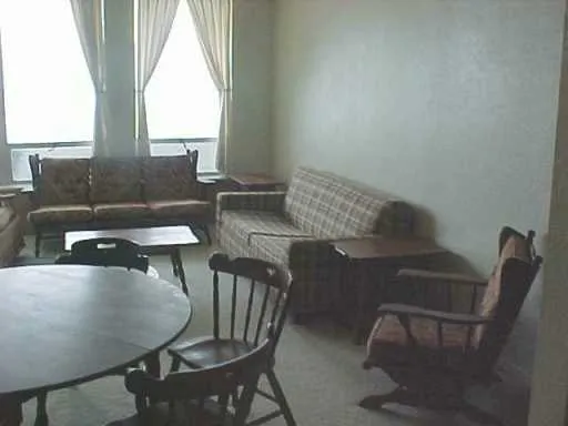 a view of a dining room with furniture and a window