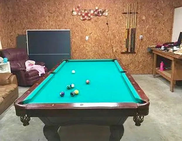 a room with pool table and a chandelier