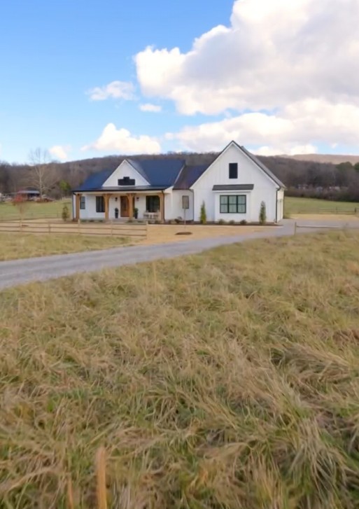 640 Dotson Cemetery Road Decherd, TN 37324 - Photo 7 of 18 a front view of a house with a garden and lake view