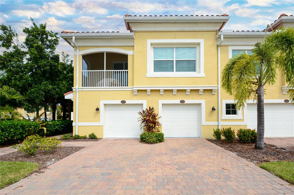4212 Expedition Way Osprey, FL 34229 - Photo 1 of 28 a front view of a house with garden
