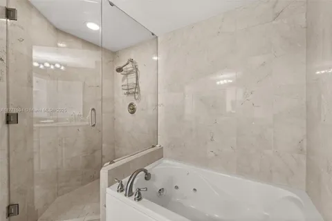 a bathroom with a bathtub and shower