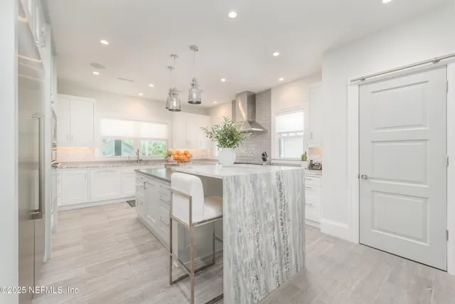 a view of a dining room with furniture a chandelier and wooden floor