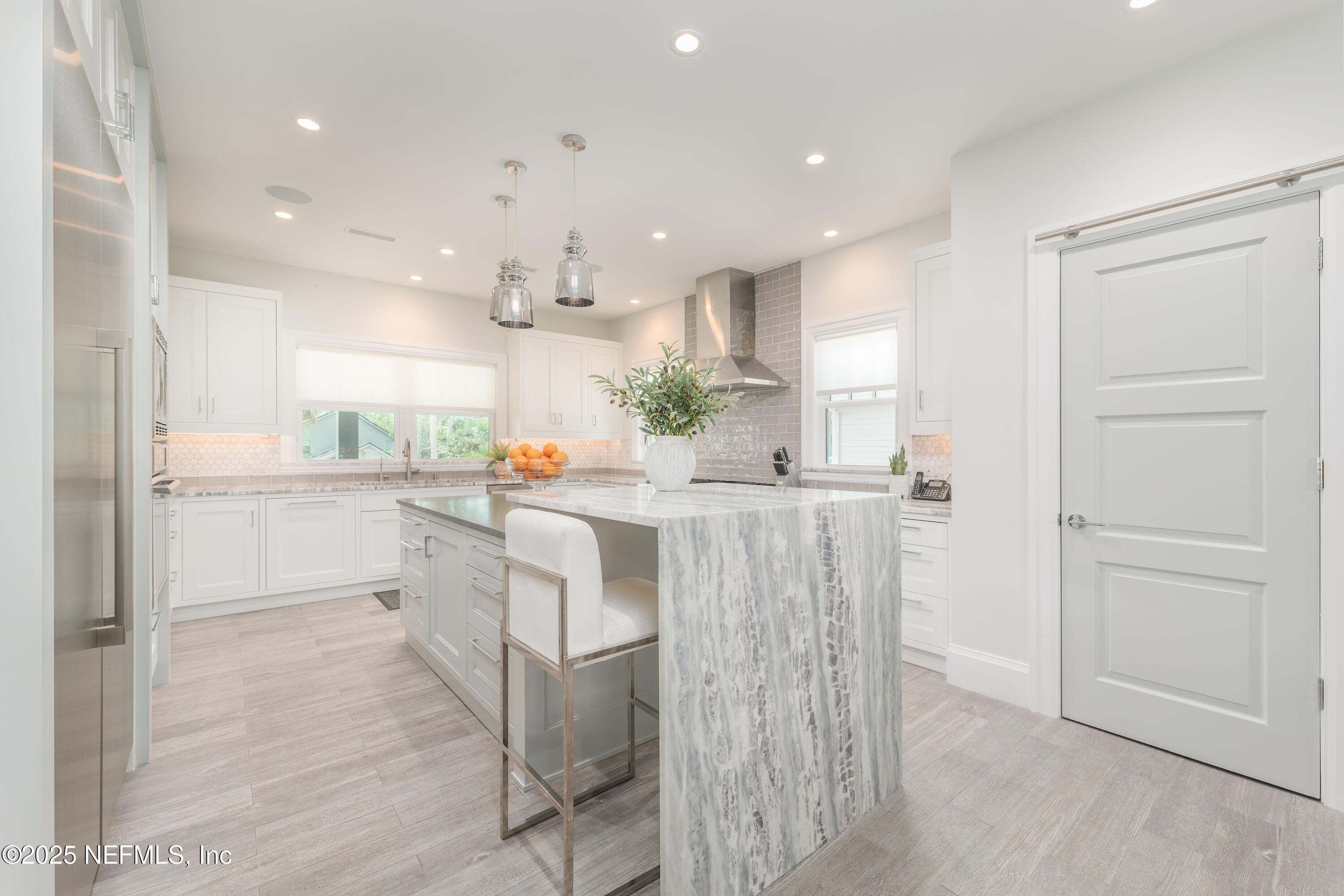 365 8th Street Atlantic Beach, FL 32233 - Photo 11 of 65 a kitchen with white cabinets and refrigerator
