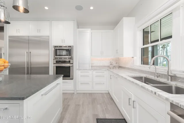a view of a dining room with furniture a chandelier and wooden floor