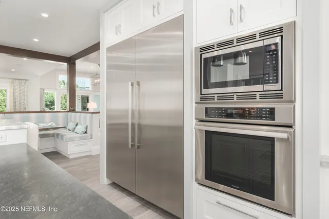 a living room with furniture and view of kitchen