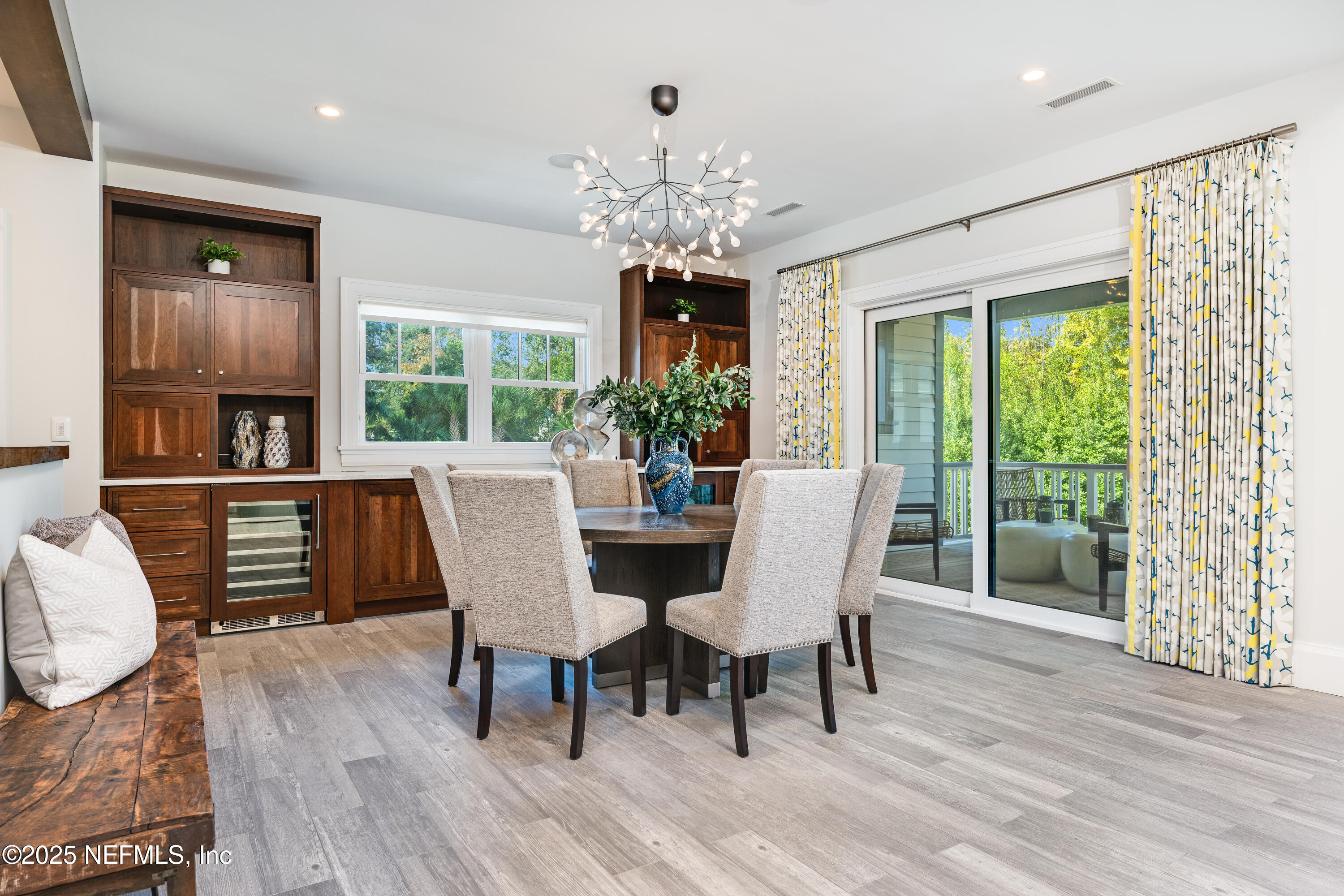365 8th Street Atlantic Beach, FL 32233 - Photo 17 of 65 a view of a dining room with furniture a chandelier and wooden floor