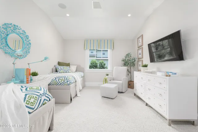 a living room with stainless steel appliances furniture a dining table and kitchen view