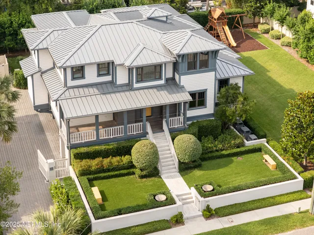 a aerial view of a house with swimming pool and a yard