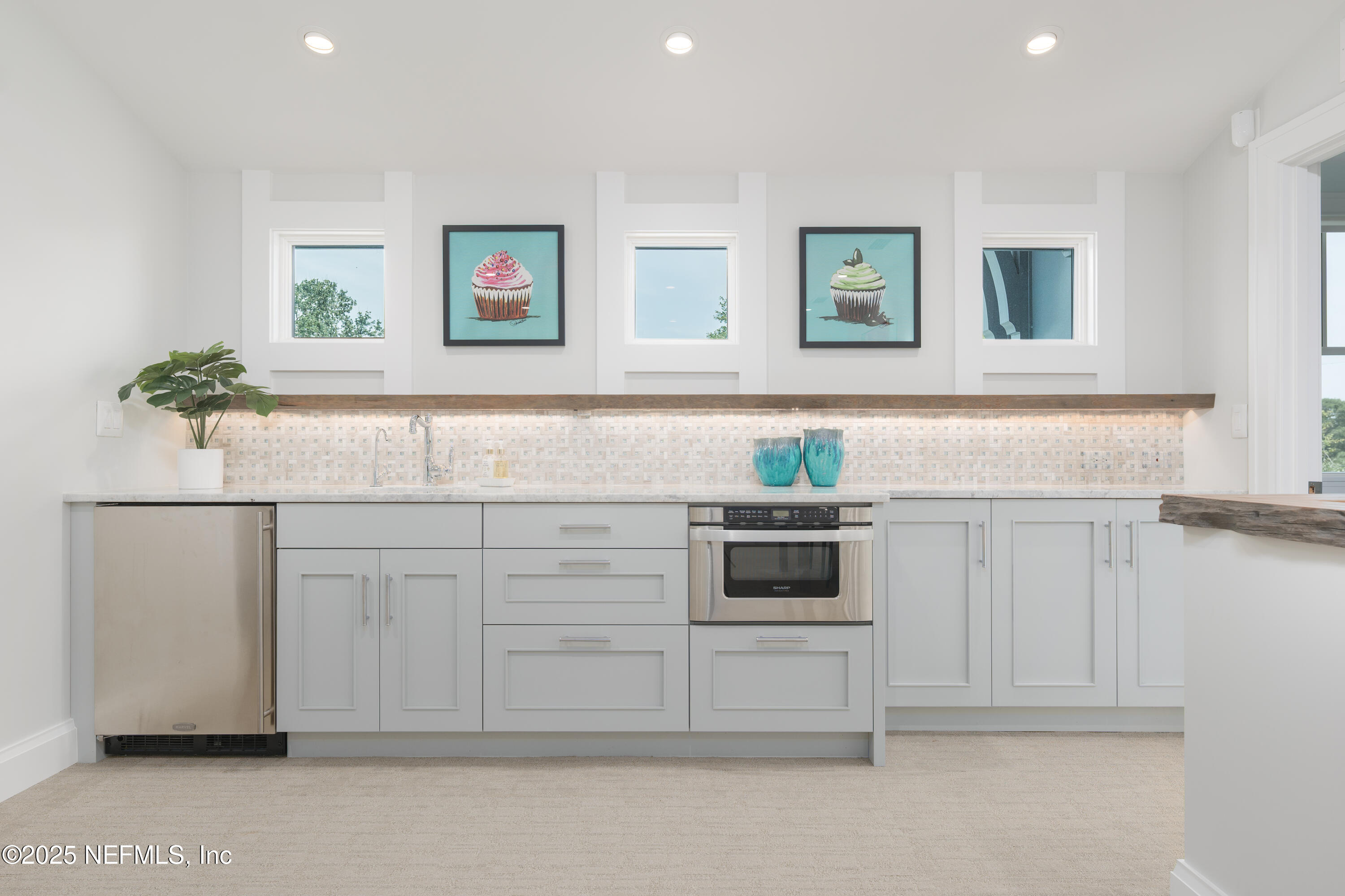 365 8th Street Atlantic Beach, FL 32233 - Photo 40 of 65 a kitchen with white cabinets and white appliances