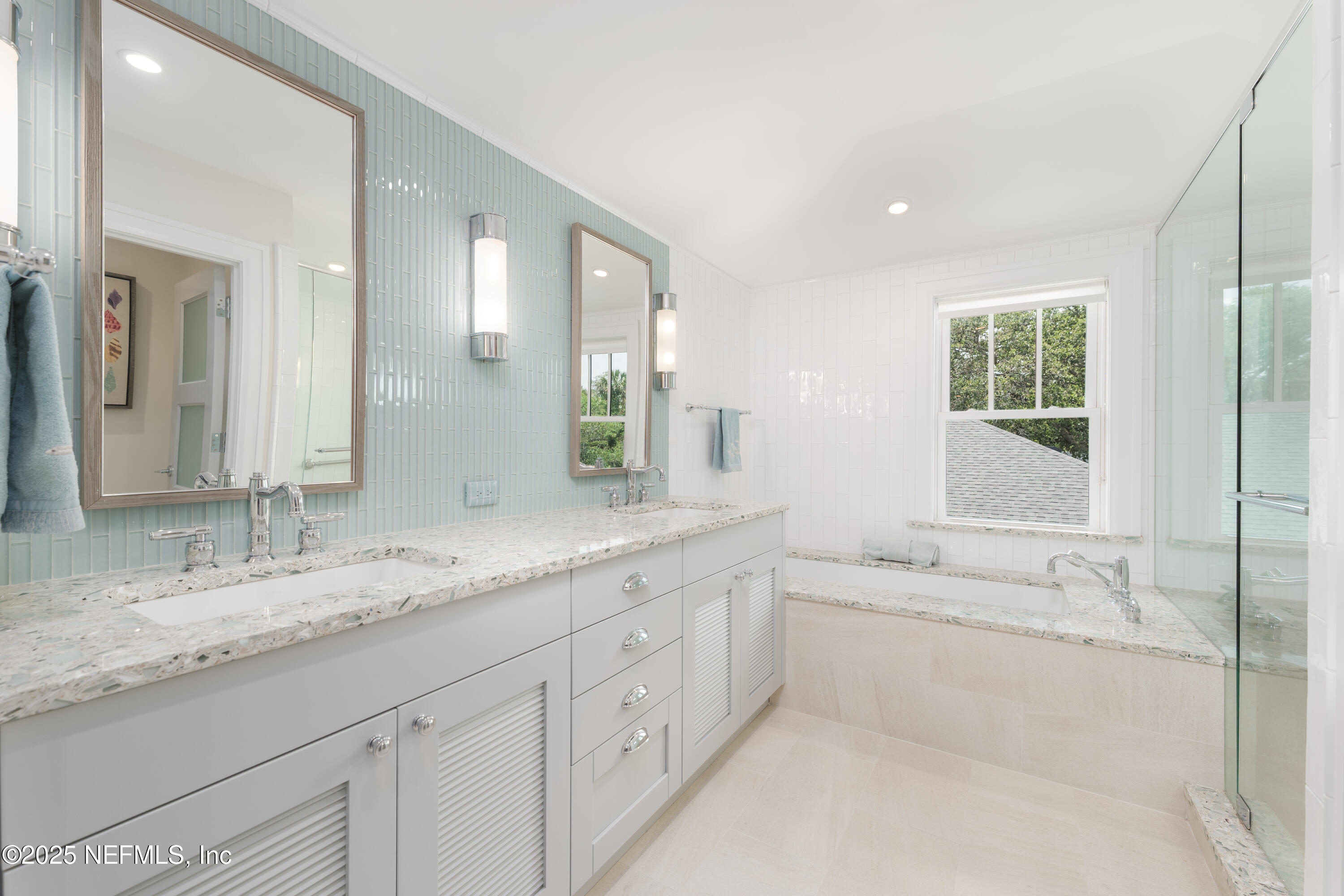 365 8th Street Atlantic Beach, FL 32233 - Photo 44 of 65 a bathroom with a granite countertop double vanity sink a mirror and a bathtub