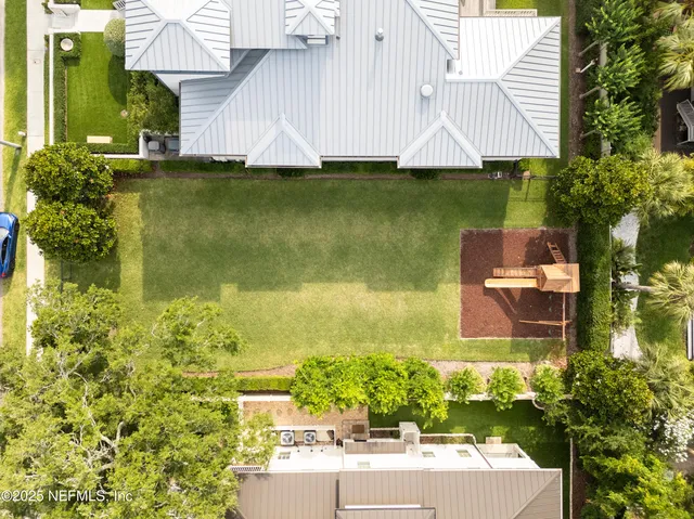an aerial view of a house with a garden statue