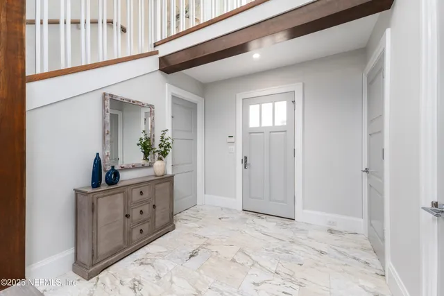 a kitchen with white cabinets and refrigerator