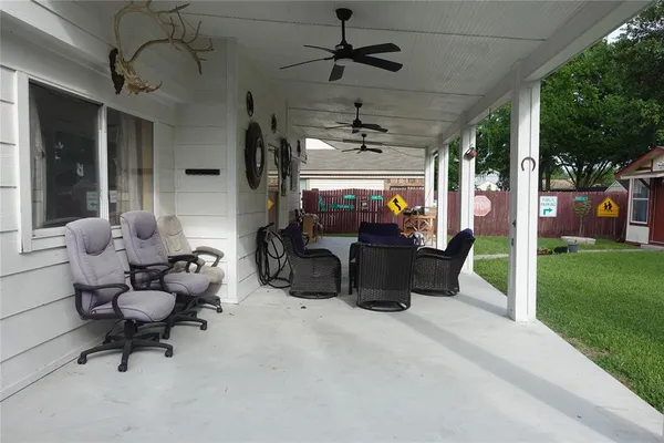 a living room with patio furniture and garden