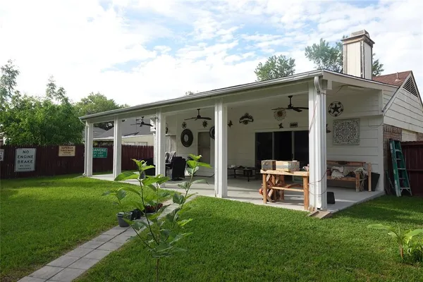 a view of a house with a yard and sitting area