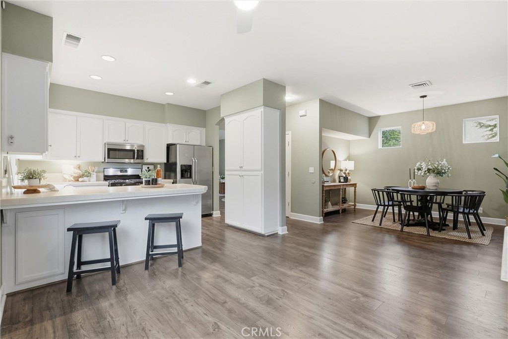 97 Benson Terrace Chico, CA 95928 - Photo 27 of 39 a kitchen with stainless steel appliances granite countertop a dining table chairs stove refrigerator and cabinets
