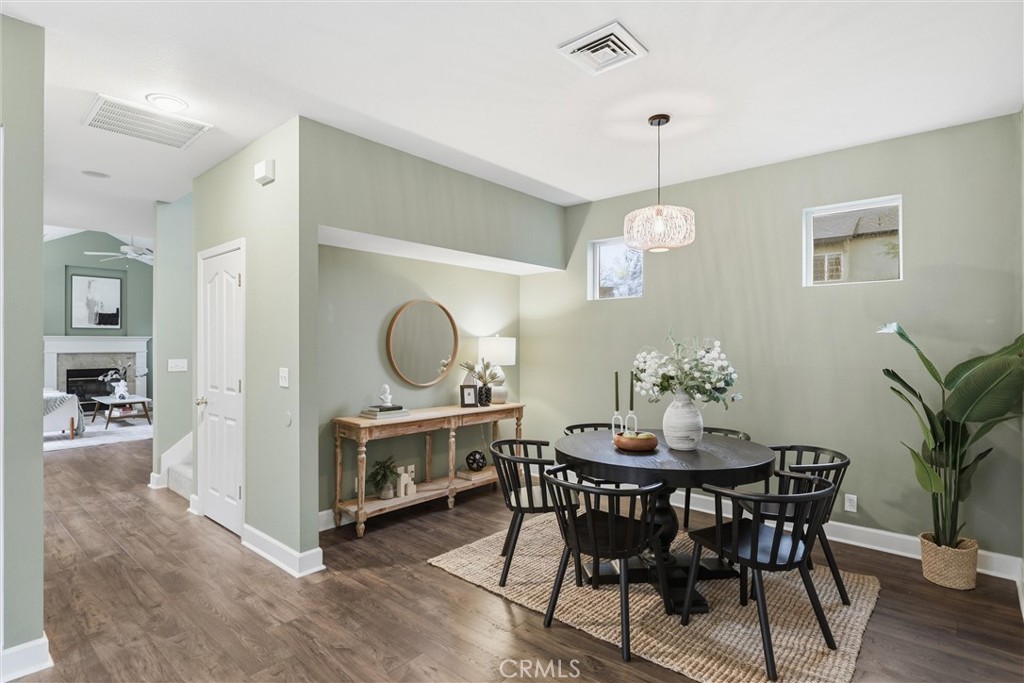 97 Benson Terrace Chico, CA 95928 - Photo 28 of 39 a dining room with wooden floor a chandelier a wooden table and chairs