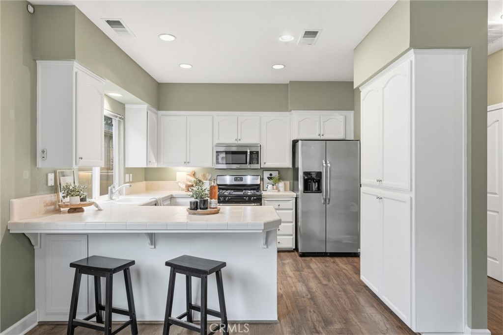 97 Benson Terrace Chico, CA 95928 - Photo 4 of 39 a kitchen with kitchen island granite countertop a sink cabinets and stainless steel appliances