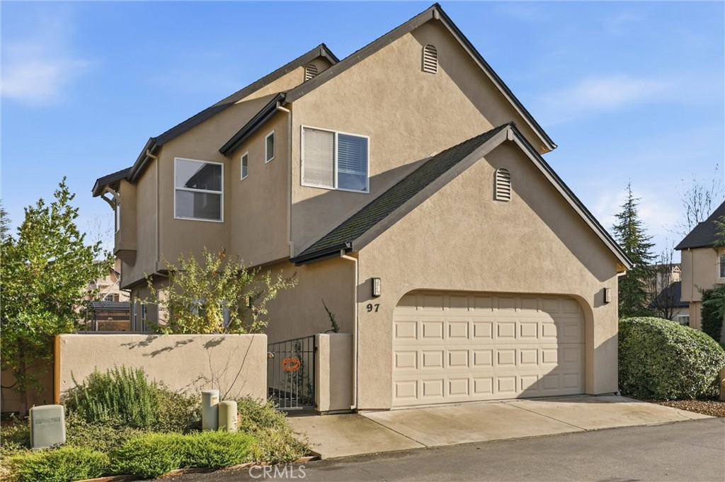 97 Benson Terrace Chico, CA 95928 - Photo 7 of 39 a view of a house with a yard and garage
