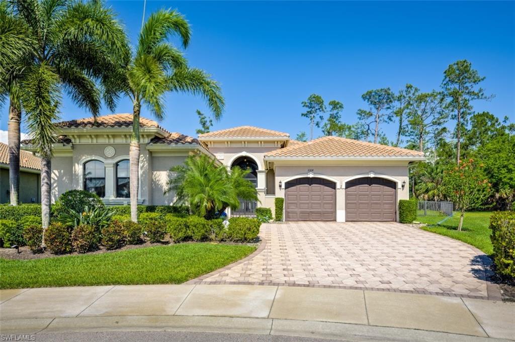 Undisclosed Address Naples, FL 34119 - Photo 1 of 32 a front view of a house with a garden