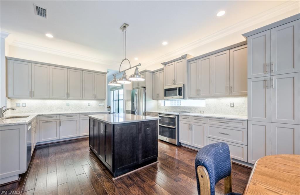 Undisclosed Address Naples, FL 34119 - Photo 11 of 32 a kitchen with a sink stove and cabinets