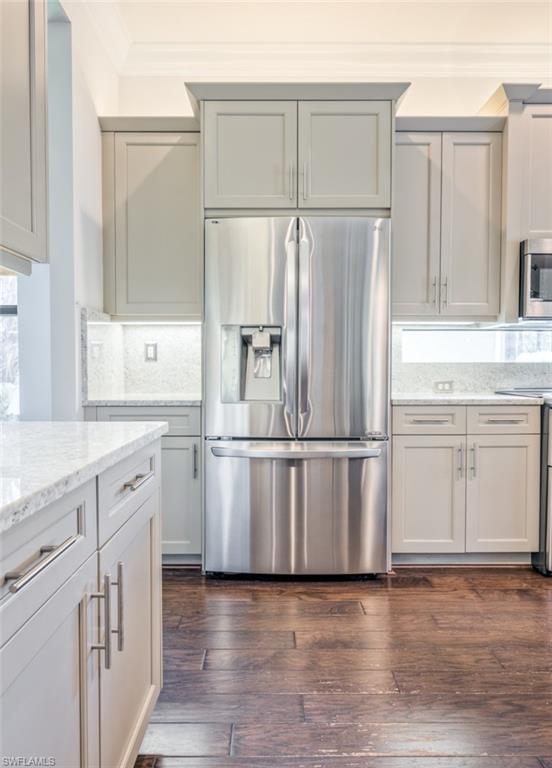 Undisclosed Address Naples, FL 34119 - Photo 12 of 32 a kitchen with white cabinets and white stainless steel appliances