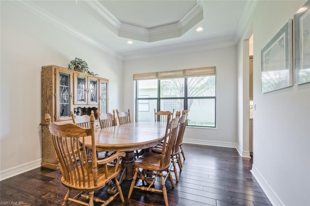 Undisclosed Address Naples, FL 34119 - Photo 15 of 32 a view of a dining room with furniture window and wooden floor