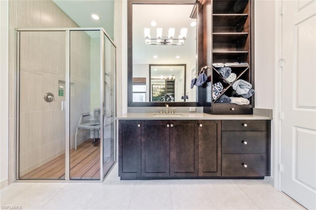 Undisclosed Address Naples, FL 34119 - Photo 21 of 32 a bathroom with a sink a vanity and a shower