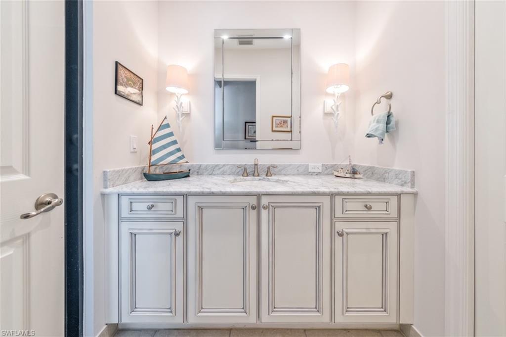 Undisclosed Address Naples, FL 34119 - Photo 29 of 32 a bathroom with a sink vanity and mirror