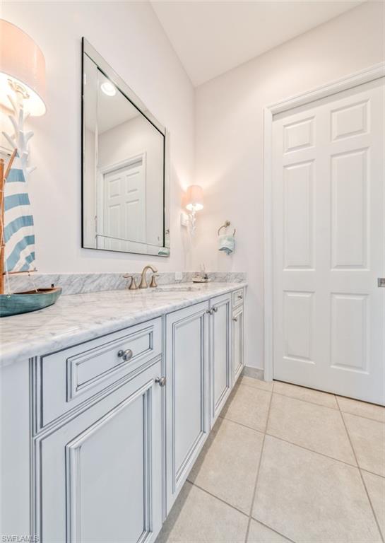 Undisclosed Address Naples, FL 34119 - Photo 30 of 32 a spacious bathroom with a granite countertop sink and a mirror