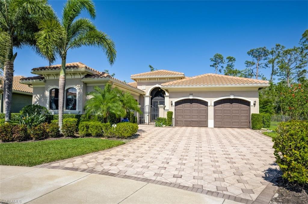 Undisclosed Address Naples, FL 34119 - Photo 31 of 32 a front view of a house with a yard