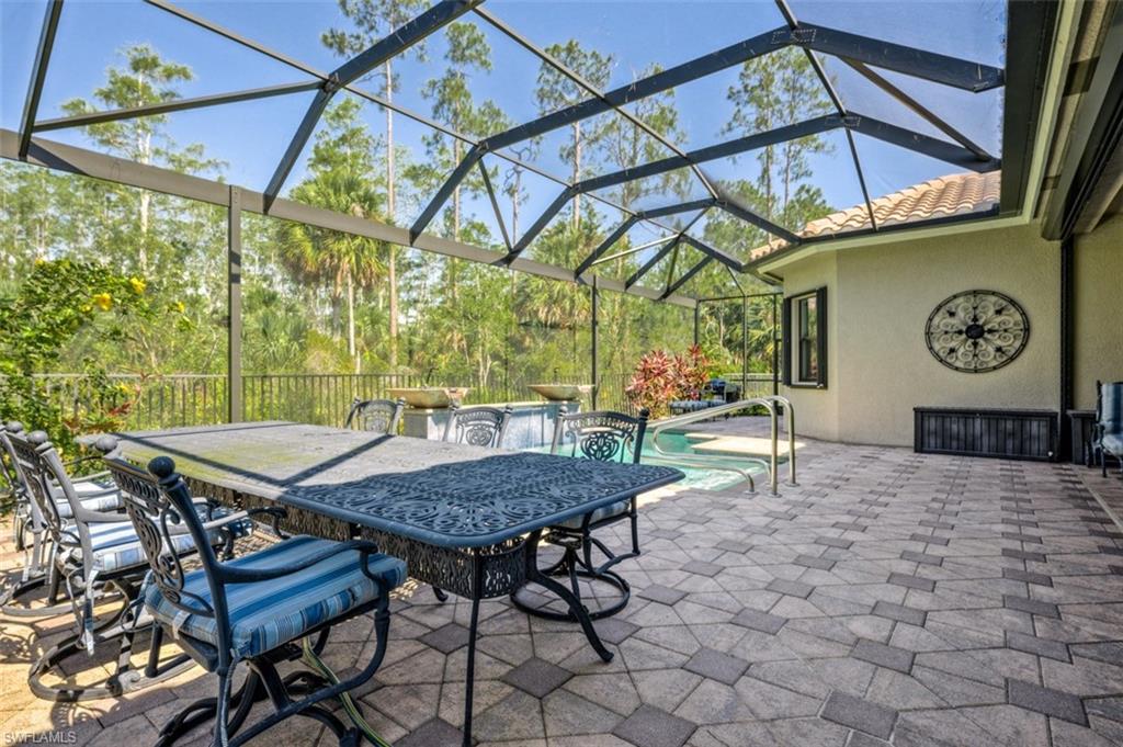 Undisclosed Address Naples, FL 34119 - Photo 4 of 32 a roof deck with table and chairs