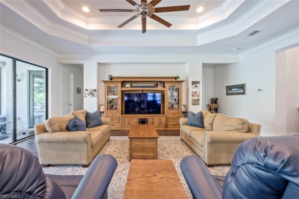 Undisclosed Address Naples, FL 34119 - Photo 5 of 32 a living room with furniture and a fireplace