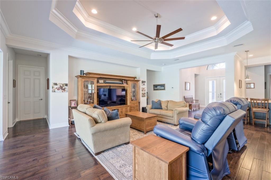 Undisclosed Address Naples, FL 34119 - Photo 7 of 32 a living room with furniture a ceiling fan and a rug