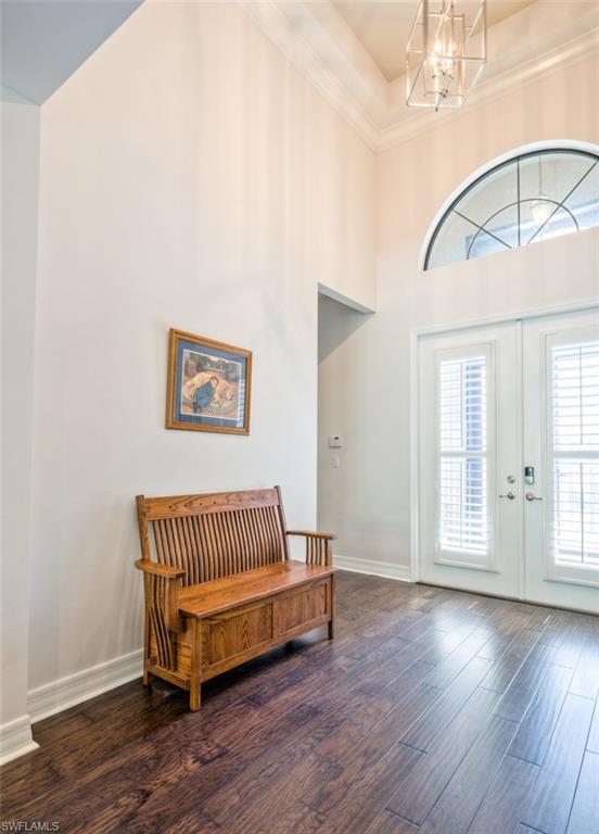 Undisclosed Address Naples, FL 34119 - Photo 9 of 32 a view of a room with wooden floor and windows