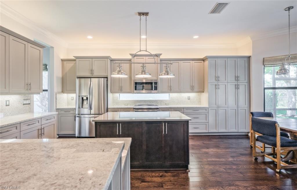 Undisclosed Address Naples, FL 34119 - Photo 10 of 32 a kitchen with stainless steel appliances granite countertop a stove and a refrigerator